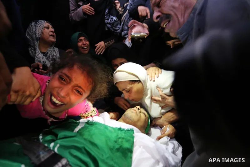 Relatives of Palestinian Mohammed Anshasi, 18, who was shot dead by Israeli forces during clashes in tents protest where Palestinians demand the right to return to their homeland at the Israel-Gaza border, mourn over his...