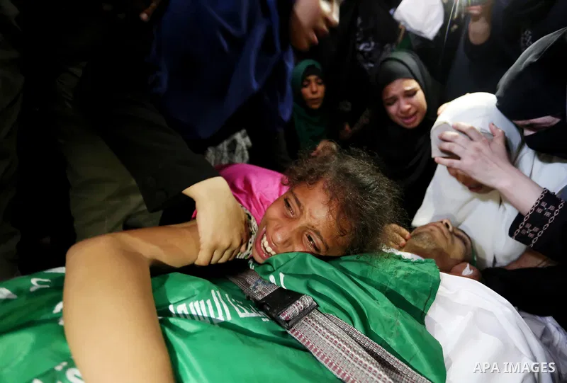 Relatives of Palestinian Mohammed Anshasi, 18, who was shot dead by Israeli forces during clashes in tents protest where Palestinians demand the right to return to their homeland at the Israel-Gaza border, mourn over his...
