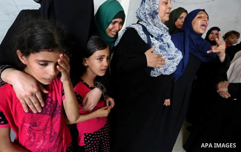 Relatives of Palestinian Mohammed Anshasi, 18, who was shot dead by Israeli forces during clashes in tents protest where Palestinians demand the right to return to their homeland at the Israel-Gaza border, mourn during h...
