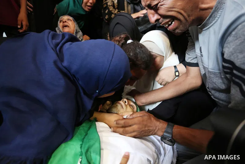 Relatives of Palestinian Mohammed Anshasi, 18, who was shot dead by Israeli forces during clashes in tents protest where Palestinians demand the right to return to their homeland at the Israel-Gaza border, mourn over his...