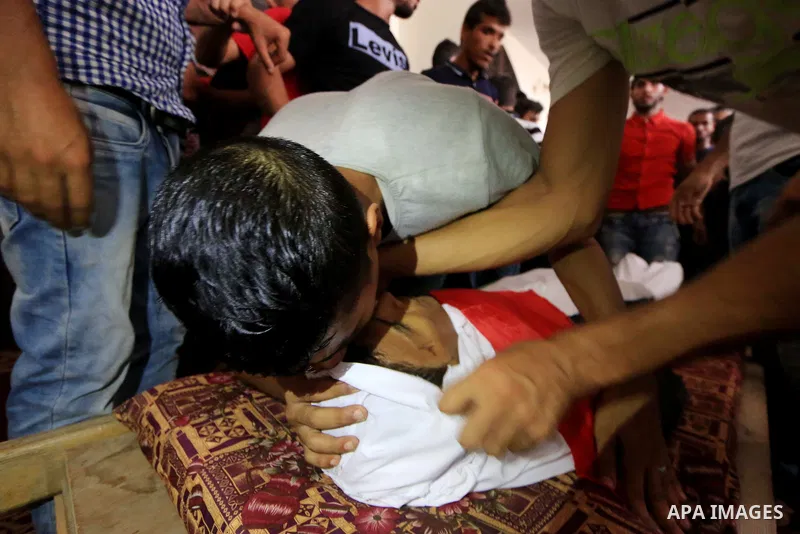 Relatives of Palestinian Mohammed Awawdeh who was shot dead by Israeli forces during clashes in tents protest where Palestinians demand the right to return to their homeland at the Israel-Gaza border, mourn over his body...