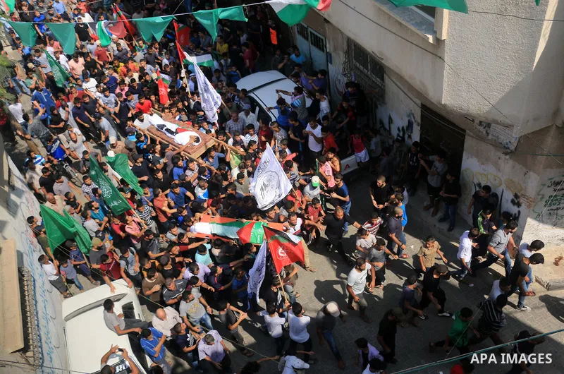 Mourners carry bodies of two Palestinian Mohammed Awawdeh and Mohammed al-Houm who were shot dead by Israeli forces during clashes in tents protest where Palestinians demand the right to return to their homeland at the I...