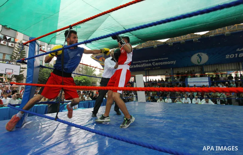 Palestinian fighters compete during the first individual boxing tournament at the University College of Applied Sciences "UCAS" in Gaza city, on September 30, 2018. Photo by Mahmoud Ajjour