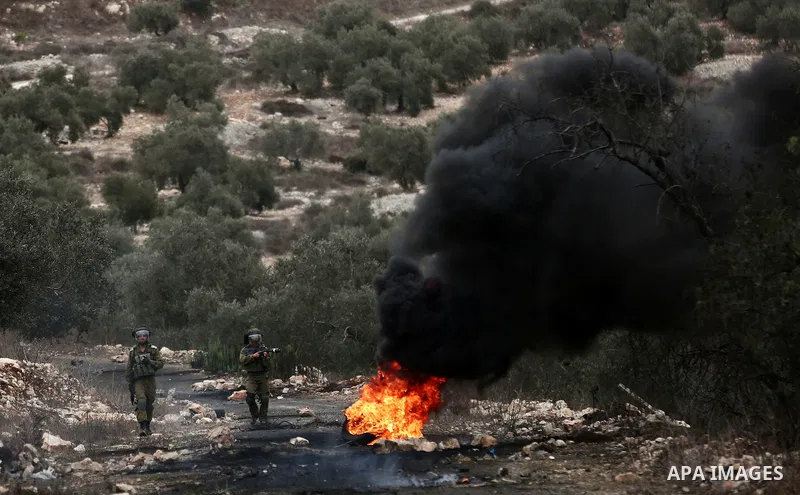 Israeli troops take position during clashes with Palestinian protesters against Israel's Nation State Law, and Israel's plan to demolish the Khan al-Ahmar village in the village of Kfar Qaddum, near the West Bank city of...