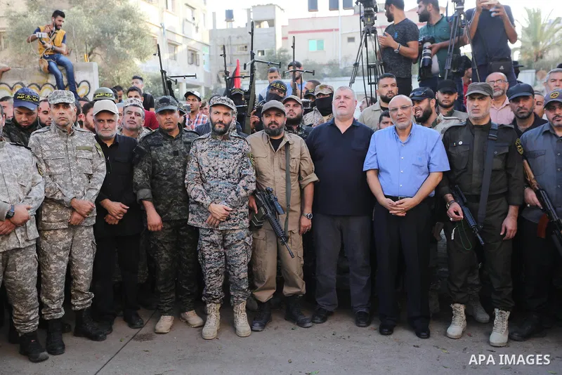 Palestinian members of the Al-Quds Brigades, the military wing of the Islamic Jihad group, march with their weapons to show loyalty for the Iranian-backed Palestinian movement's newly elected leader Ziad al-Nakhalah duri...
