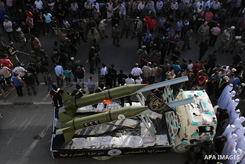 Palestinian members of the Al-Quds Brigades, the military wing of the Islamic Jihad group, march with their weapons to show loyalty for the Iranian-backed Palestinian movement's newly elected leader Ziad al-Nakhalah duri...