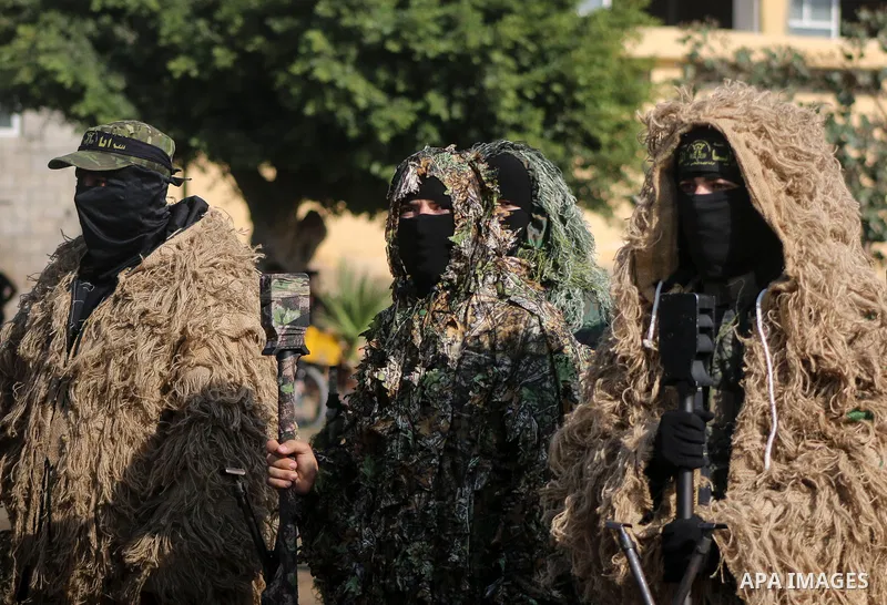 Palestinian members of the Al-Quds Brigades, the military wing of the Islamic Jihad group, take part with their weapons to show loyalty for the Palestinian movement's newly elected leader Ziad al-Nakhalah during a rally...