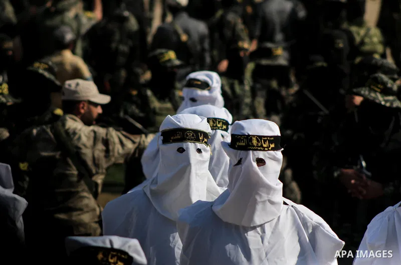 Palestinian members of the Al-Quds Brigades, the military wing of the Islamic Jihad group, take part with their weapons to show loyalty for the Palestinian movement's newly elected leader Ziad al-Nakhalah during a rally...