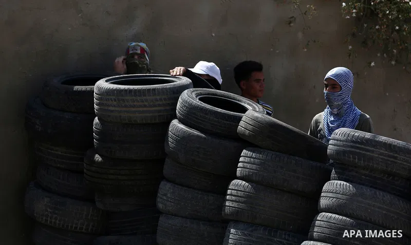 Palestinian protesters hurl stones towards Israeli forces during clashes following a weekly demonstration against the expropriation of Palestinian land by Israel in the village of Kfar Qaddum, near the West Bank city of...