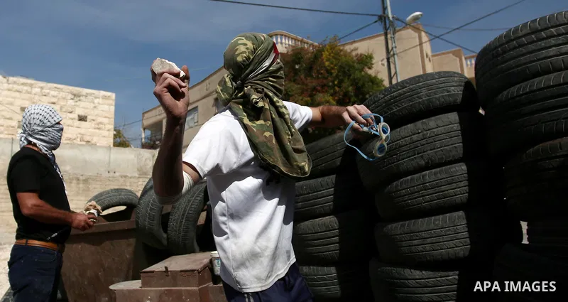 Palestinian protesters hurl stones towards Israeli forces during clashes following a weekly demonstration against the expropriation of Palestinian land by Israel in the village of Kfar Qaddum, near the West Bank city of...