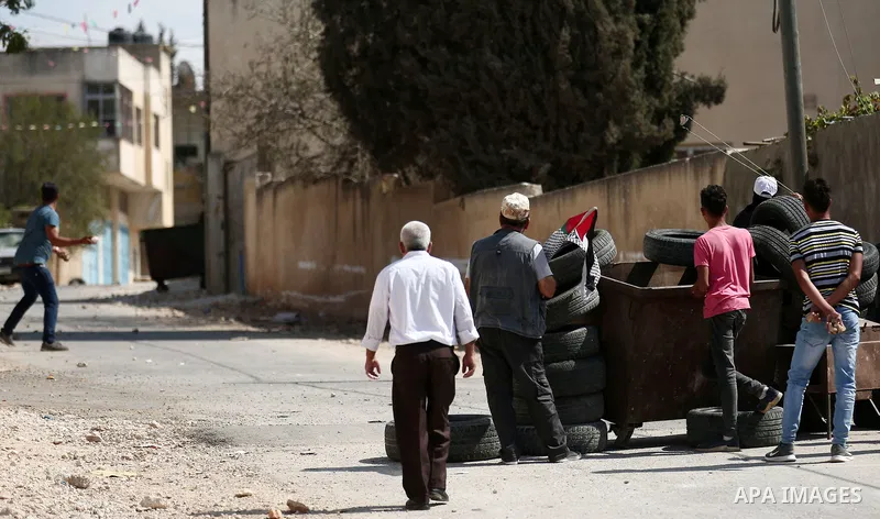 Palestinian protesters hurl stones towards Israeli forces during clashes following a weekly demonstration against the expropriation of Palestinian land by Israel in the village of Kfar Qaddum, near the West Bank city of...