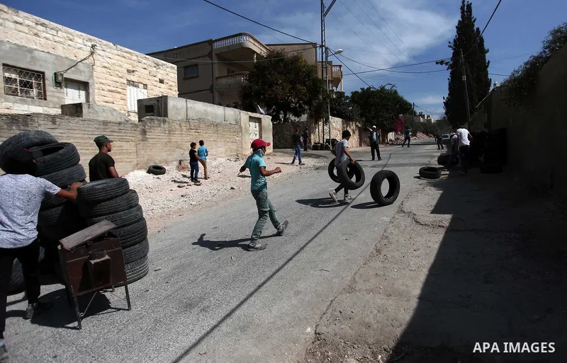 Palestinian protesters hurl stones towards Israeli forces during clashes following a weekly demonstration against the expropriation of Palestinian land by Israel in the village of Kfar Qaddum, near the West Bank city of...