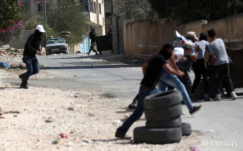 Palestinian protesters hurl stones towards Israeli forces during clashes following a weekly demonstration against the expropriation of Palestinian land by Israel in the village of Kfar Qaddum, near the West Bank city of...