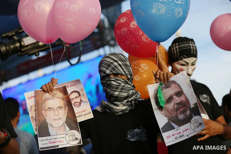 Palestinians watch the speech of newly elected leader of Islamic Jihad movement, Ziad al-Nakhalah, on a large screen in tents protest where Palestinians demand the right to return to their homeland at the Israel-Gaza bor...