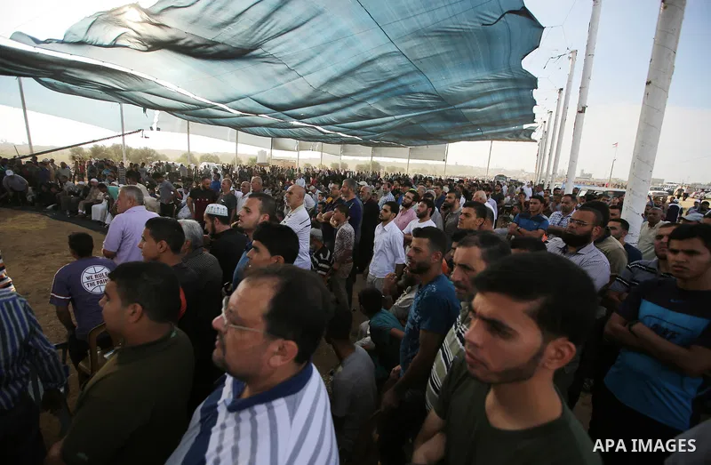 Palestinians watch the speech of newly elected leader of Islamic Jihad movement, Ziad al-Nakhalah, on a large screen in tents protest where Palestinians demand the right to return to their homeland at the Israel-Gaza bor...