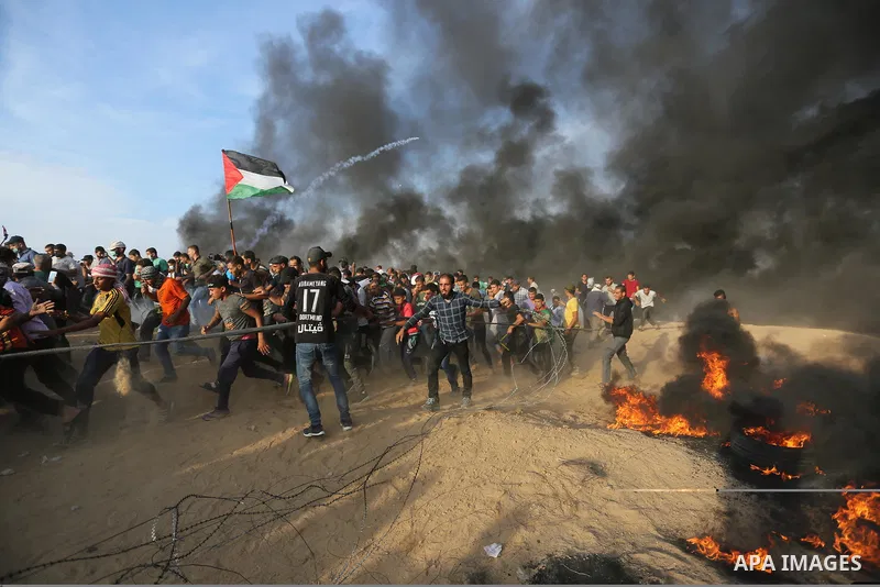 Palestinian protesters gather during clashes with Israeli troops in tents protest where Palestinians demand the right to return to their homeland at the Israel-Gaza border, in Khan Younis in the southern Gaza Strip on Oc...