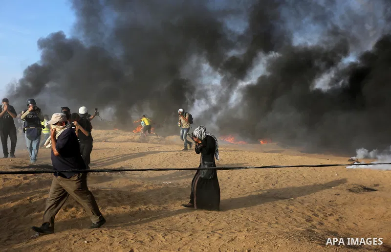 Palestinian protesters gather during clashes with Israeli troops in tents protest where Palestinians demand the right to return to their homeland at the Israel-Gaza border, in Khan Younis in the southern Gaza Strip on Oc...