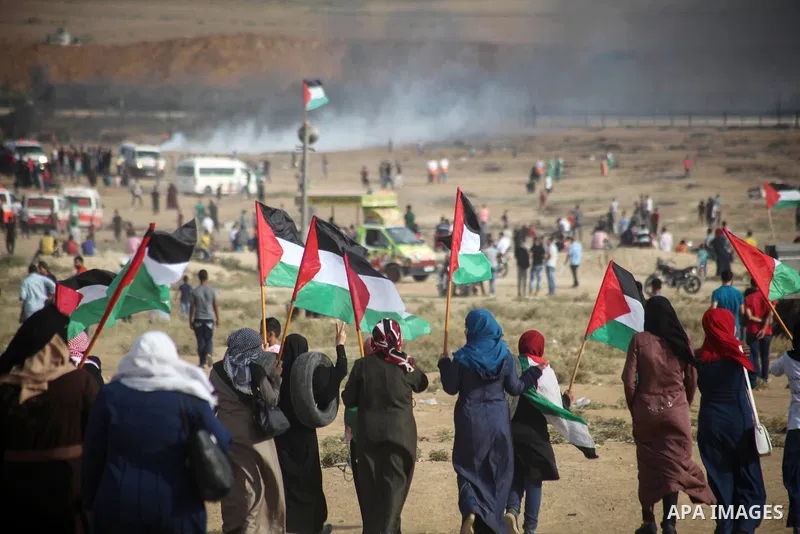 Palestinian protesters gather during clashes with Israeli troops in tents protest where Palestinians demand the right to return to their homeland at the Israel-Gaza border, in Jabalia in the northern of Gaza Strip on Oct...