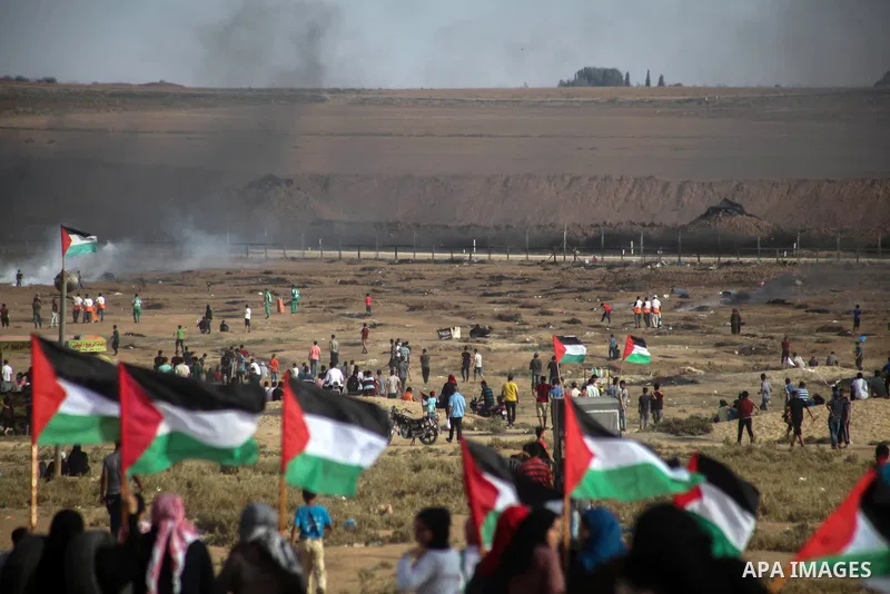 Palestinian protesters gather during clashes with Israeli troops in tents protest where Palestinians demand the right to return to their homeland at the Israel-Gaza border, in Jabalia in the northern of Gaza Strip on Oct...