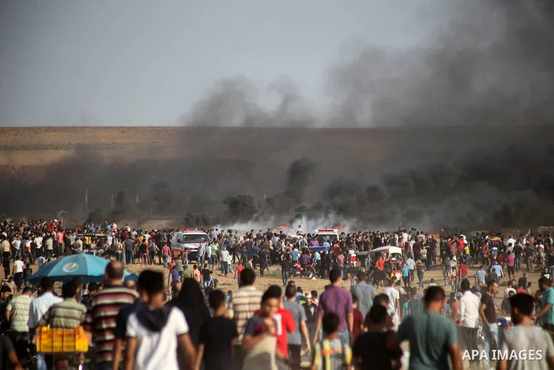 Palestinian protesters gather during clashes with Israeli troops in tents protest where Palestinians demand the right to return to their homeland at the Israel-Gaza border, in Jabalia in the northern of Gaza Strip on Oct...