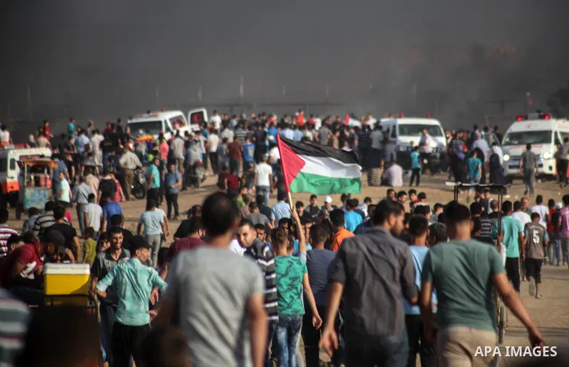 Palestinian protesters gather during clashes with Israeli troops in tents protest where Palestinians demand the right to return to their homeland at the Israel-Gaza border, in Jabalia in the northern of Gaza Strip on Oct...