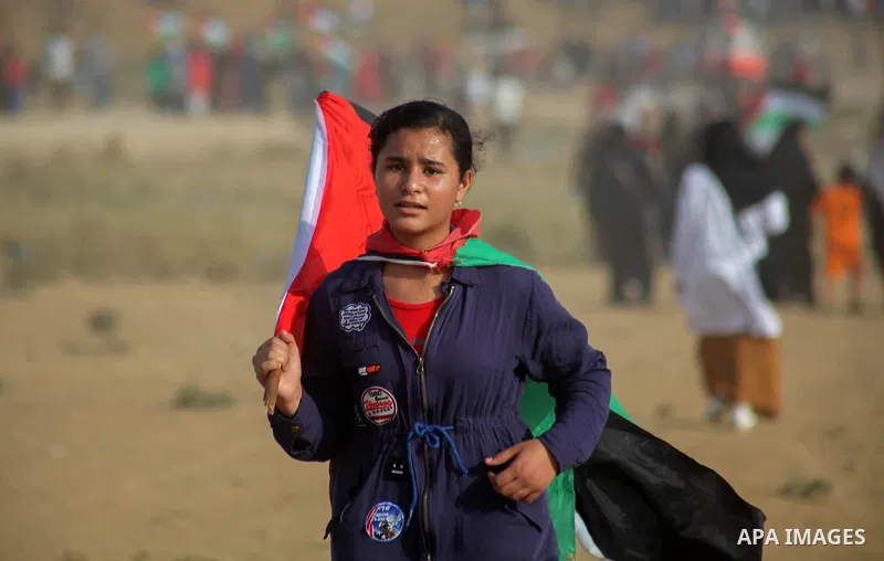 Palestinian protesters gather during clashes with Israeli troops in tents protest where Palestinians demand the right to return to their homeland at the Israel-Gaza border, in Jabalia in the northern of Gaza Strip on Oct...