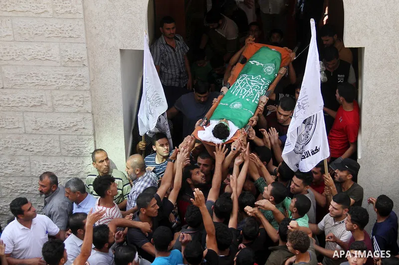 Mourners carry the body of Palestinian boy Faris al-Sersawi, 12, who was shot dead by Israeli froces during clashes in tents protest where Palestinians demand the right to return to their homeland at the Israel-Gaza bord...