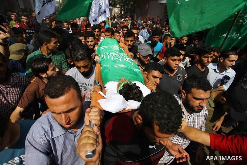 Mourners carry the body of Palestinian boy Faris al-Sersawi, 12, who was shot dead by Israeli froces during clashes in tents protest where Palestinians demand the right to return to their homeland at the Israel-Gaza bord...