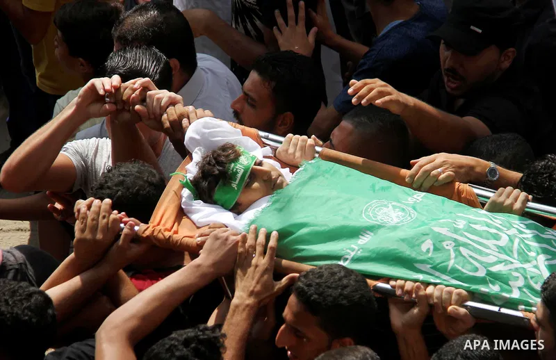 Mourners carry the body of Palestinian boy Faris al-Sersawi, 12, who was shot dead by Israeli froces during clashes in tents protest where Palestinians demand the right to return to their homeland at the Israel-Gaza bord...
