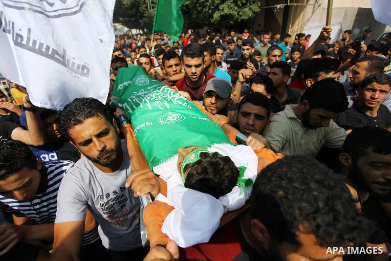 Mourners carry the body of Palestinian boy Faris al-Sersawi, 12, who was shot dead by Israeli froces during clashes in tents protest where Palestinians demand the right to return to their homeland at the Israel-Gaza bord...