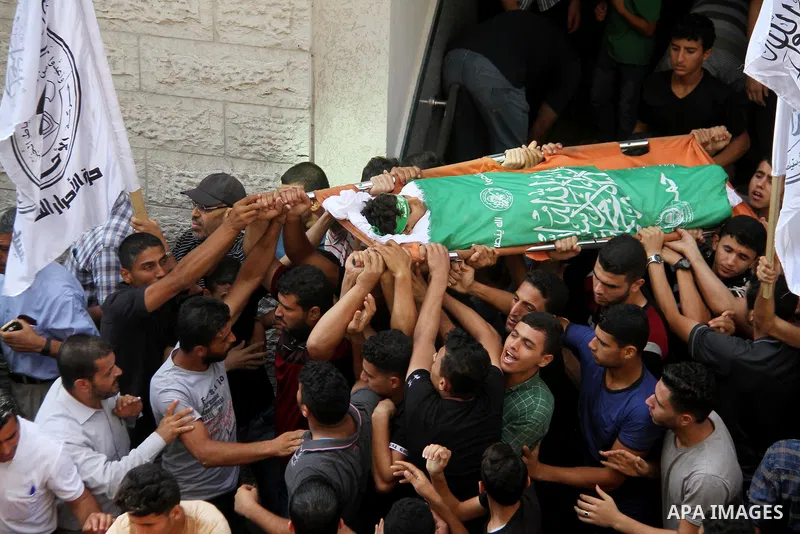 Mourners carry the body of Palestinian boy Faris al-Sersawi, 12, who was shot dead by Israeli froces during clashes in tents protest where Palestinians demand the right to return to their homeland at the Israel-Gaza bord...