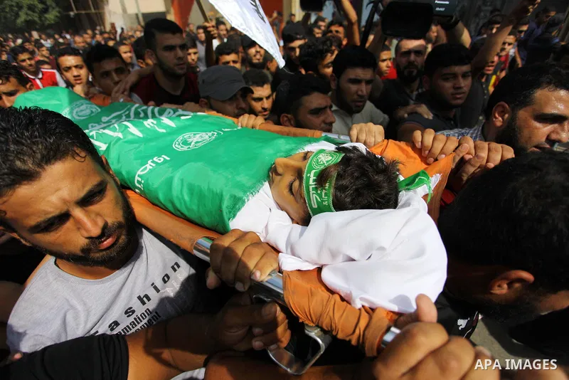 Mourners carry the body of Palestinian boy Faris al-Sersawi, 12, who was shot dead by Israeli froces during clashes in tents protest where Palestinians demand the right to return to their homeland at the Israel-Gaza bord...