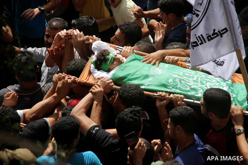 Mourners carry the body of Palestinian boy Faris al-Sersawi, 12, who was shot dead by Israeli froces during clashes in tents protest where Palestinians demand the right to return to their homeland at the Israel-Gaza bord...