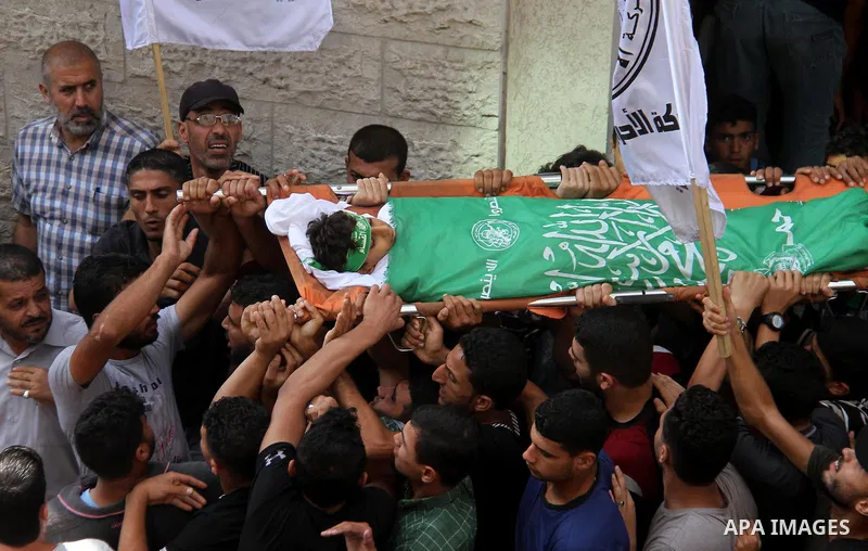 Mourners carry the body of Palestinian boy Faris al-Sersawi, 12, who was shot dead by Israeli froces during clashes in tents protest where Palestinians demand the right to return to their homeland at the Israel-Gaza bord...