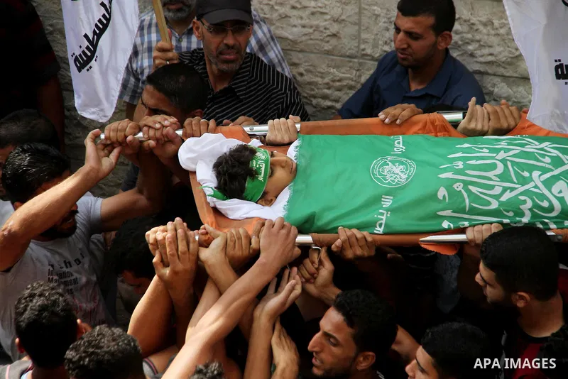 Mourners carry the body of Palestinian boy Faris al-Sersawi, 12, who was shot dead by Israeli froces during clashes in tents protest where Palestinians demand the right to return to their homeland at the Israel-Gaza bord...
