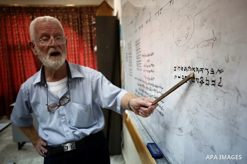 Samaritan tutor Ragheb Mfarrej ,78, teaches kids the ancient Samaritan language, at Mount Gerizim near the West Bank city of Nablus, on October 7, 2018. The kids start learning Hebrew ancient language on their 6 years ol...