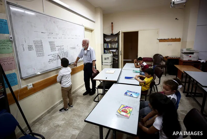 Samaritan tutor Ragheb Mfarrej ,78, teaches kids the ancient Samaritan language, at Mount Gerizim near the West Bank city of Nablus, on October 7, 2018. The kids start learning Hebrew ancient language on their 6 years ol...