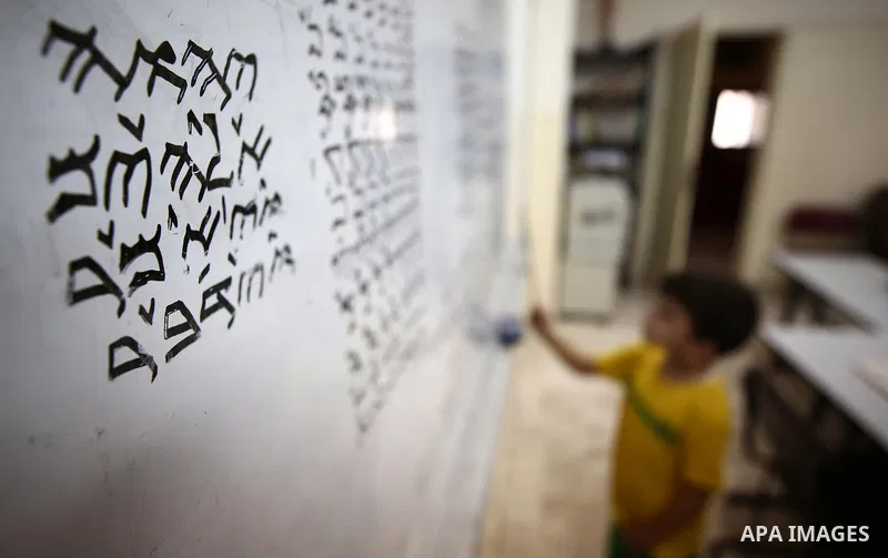 Samaritan tutor Ragheb Mfarrej ,78, teaches kids the ancient Samaritan language, at Mount Gerizim near the West Bank city of Nablus, on October 7, 2018. The kids start learning Hebrew ancient language on their 6 years ol...