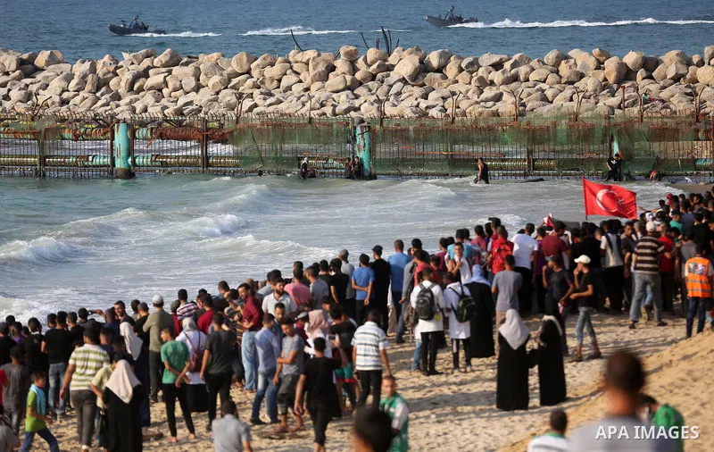 Palestinian protesters gather during clashes with Israeli forces in a demonstration against the Israeli blockade on Gaza Strip, along the Gaza sea barrier on the maritime border with Israel near Kibbutz Zikim, north of B...
