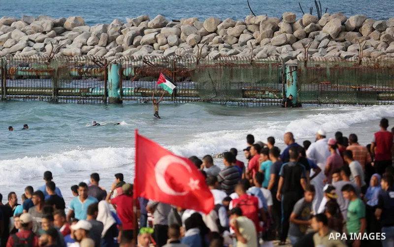 Palestinian protesters gather during clashes with Israeli forces in a demonstration against the Israeli blockade on Gaza Strip, along the Gaza sea barrier on the maritime border with Israel near Kibbutz Zikim, north of B...