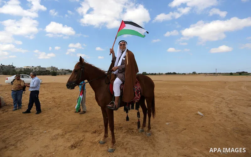 A Palestinian man rides a horse during a heritage festival at the Israel-Gaza border, in Khan Younis in the southern Gaza Strip on October 10, 2018. Photo by Ashraf Amra