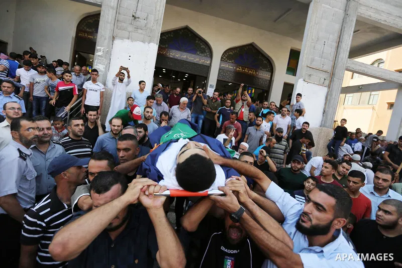 Mourners carry bodies of Palestinians Ahmed al-Tawil, 27, and Ahmed Abu Naim, 17, who were shot dead by Israeli troops during clashes in tents protest where Palestinian demand rights to return to their homeland at Israel...