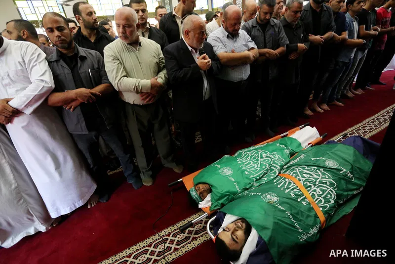 Mourners pray over the bodies of Palestinians Ahmed al-Tawil, 27, and Ahmed Abu Naim, 17, who were shot dead by Israeli troops during clashes in tents protest where Palestinian demand rights to return to their homeland a...