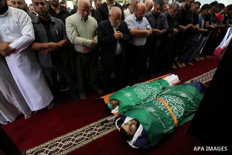 Mourners pray over the bodies of Palestinians Ahmed al-Tawil, 27, and Ahmed Abu Naim, 17, who were shot dead by Israeli troops during clashes in tents protest where Palestinian demand rights to return to their homeland a...
