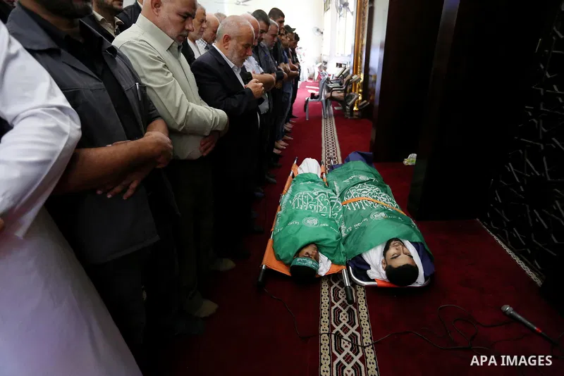 Mourners pray over the bodies of Palestinians Ahmed al-Tawil, 27, and Ahmed Abu Naim, 17, who were shot dead by Israeli troops during clashes in tents protest where Palestinian demand rights to return to their homeland a...