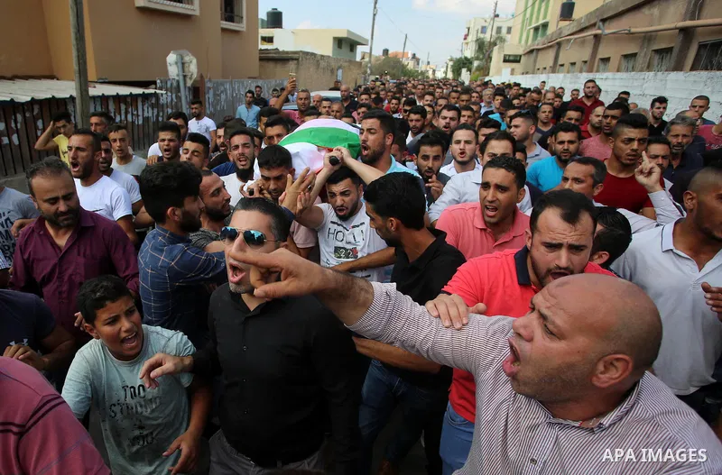 Palestinian mourners carry the body of Aisha al-Rabi, 48, during her funeral in the West Bank village of Becya, near The West Bank City of Salfit, 13 October 2018. According to media reports, al-Rabi was killed while her...