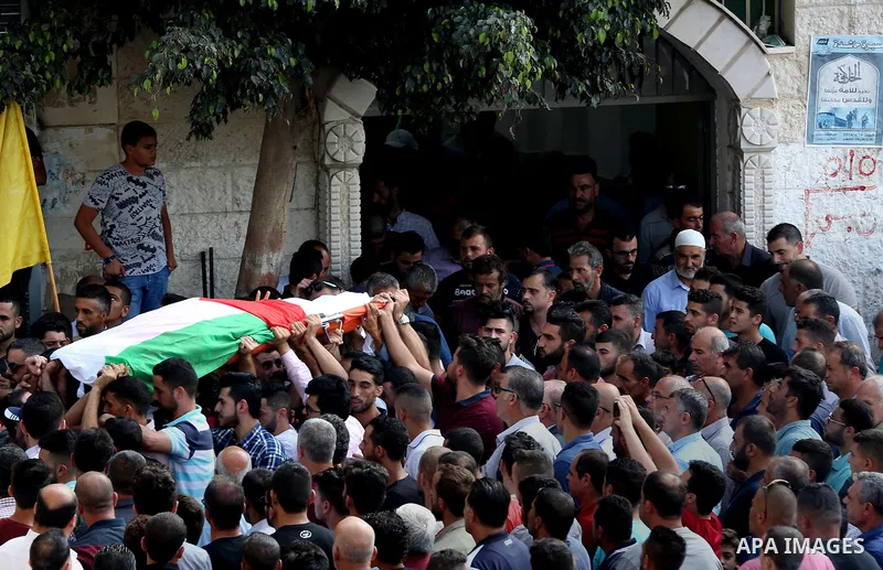 Palestinian mourners carry the body of Aisha al-Rabi, 48, during her funeral in the West Bank village of Becya, near The West Bank City of Salfit, 13 October 2018. According to media reports, al-Rabi was killed while her...