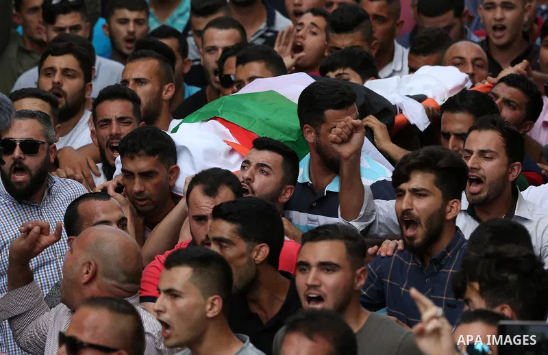 Palestinian mourners carry the body of Aisha al-Rabi, 48, during her funeral in the West Bank village of Becya, near The West Bank City of Salfit, 13 October 2018. According to media reports, al-Rabi was killed while her...