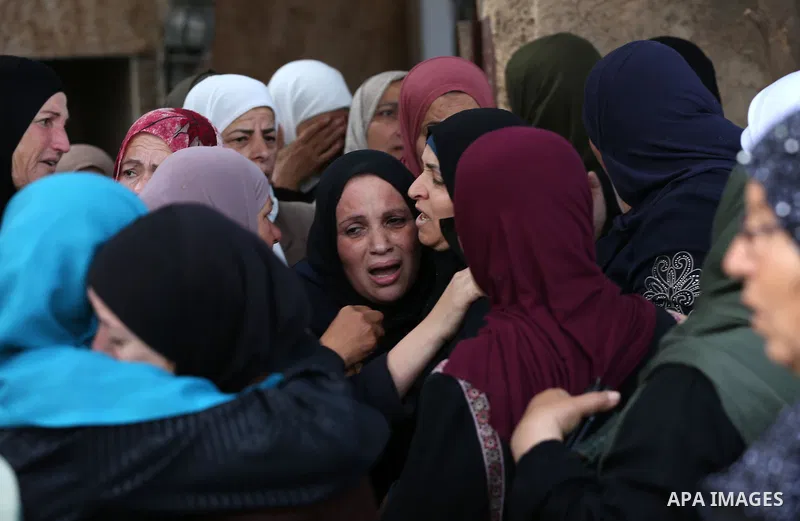 Palestinian relatives of Aisha al-Rabi, 48, weep during her funeral in the West Bank village of Becya, near The West Bank City of Salfit, 13 October 2018. According to media reports, al-Rabi was killed while her husband...