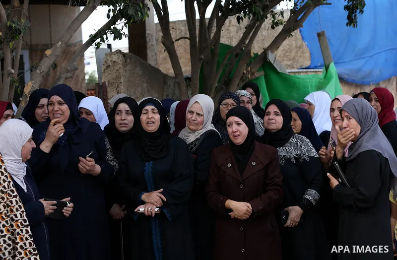Palestinian relatives of Aisha al-Rabi, 48, weep during her funeral in the West Bank village of Becya, near The West Bank City of Salfit, 13 October 2018. According to media reports, al-Rabi was killed while her husband...